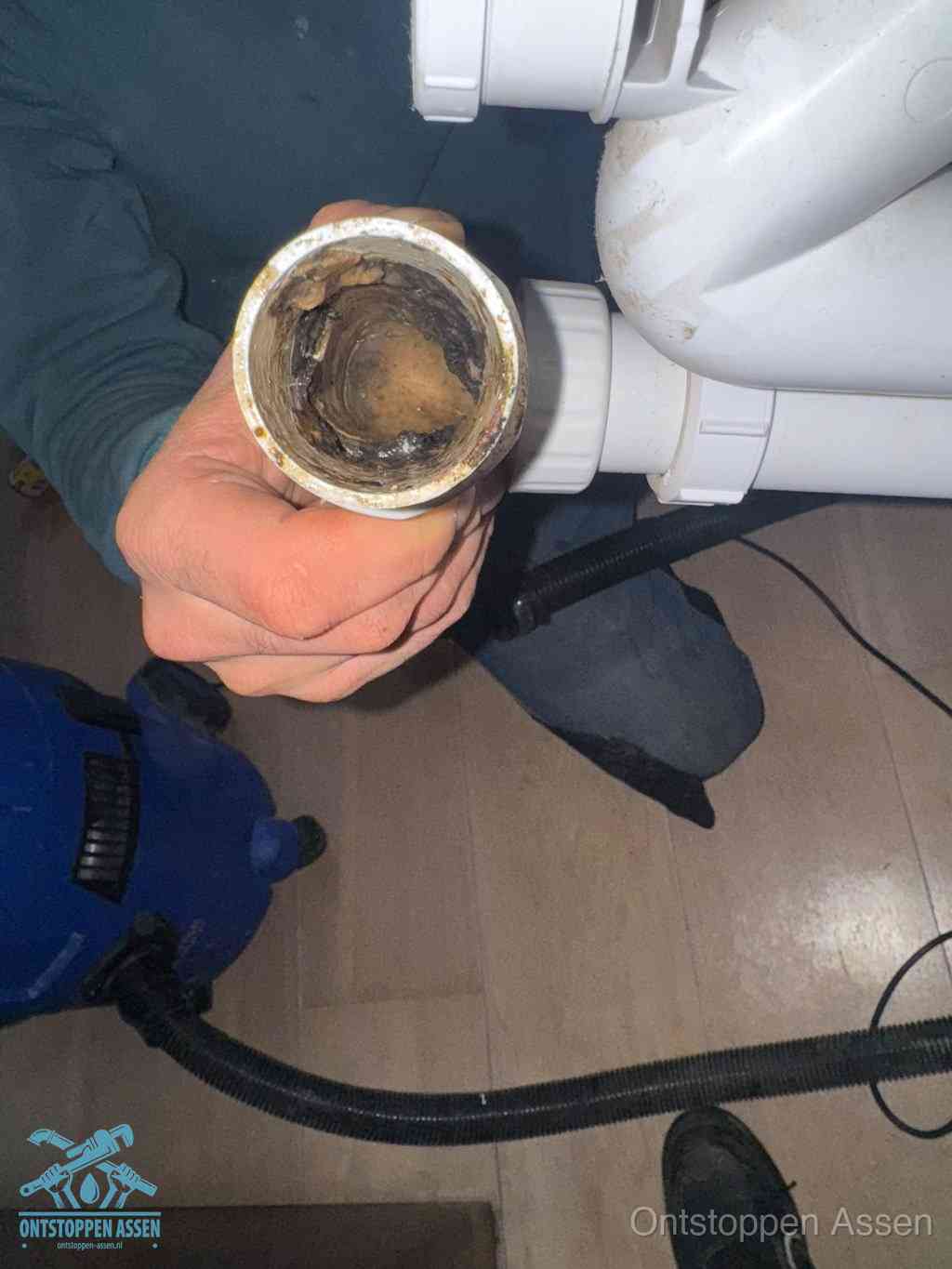 Een losgekoppeld afvoerbuisstuk dat van binnen volledig is dichtgeslibd, het gevolg van een verstopping te lang laten zitten in Assen